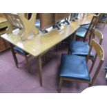 A Teak Extending Dining Table, circa 1970's on tubular legs, together with four chairs. (5).