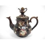 A Late XIX Century Pottery Barge Ware Teapot and Cover, with teapot finial, the bulbous body applied