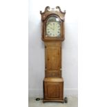 An XVIII Century Oak and Mahogany Longcase Clock, with swan neck pediment, arched door and column