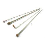 Four Victorian Glass Walking Sticks, each containing multi-coloured beads and of fluted form, 106-