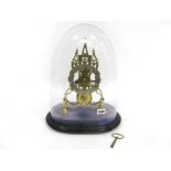 A Late XIX Century Gothic Style Brass Skeleton Clock, with three spires and turned feet, the