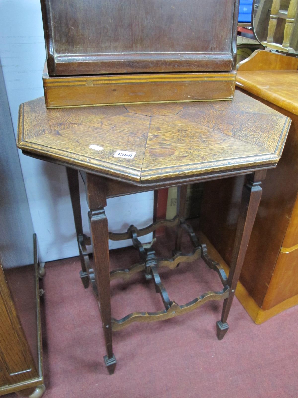 An Early XX Century Oak Window Table, with octagonal top, tapering legs, spade feet, united by