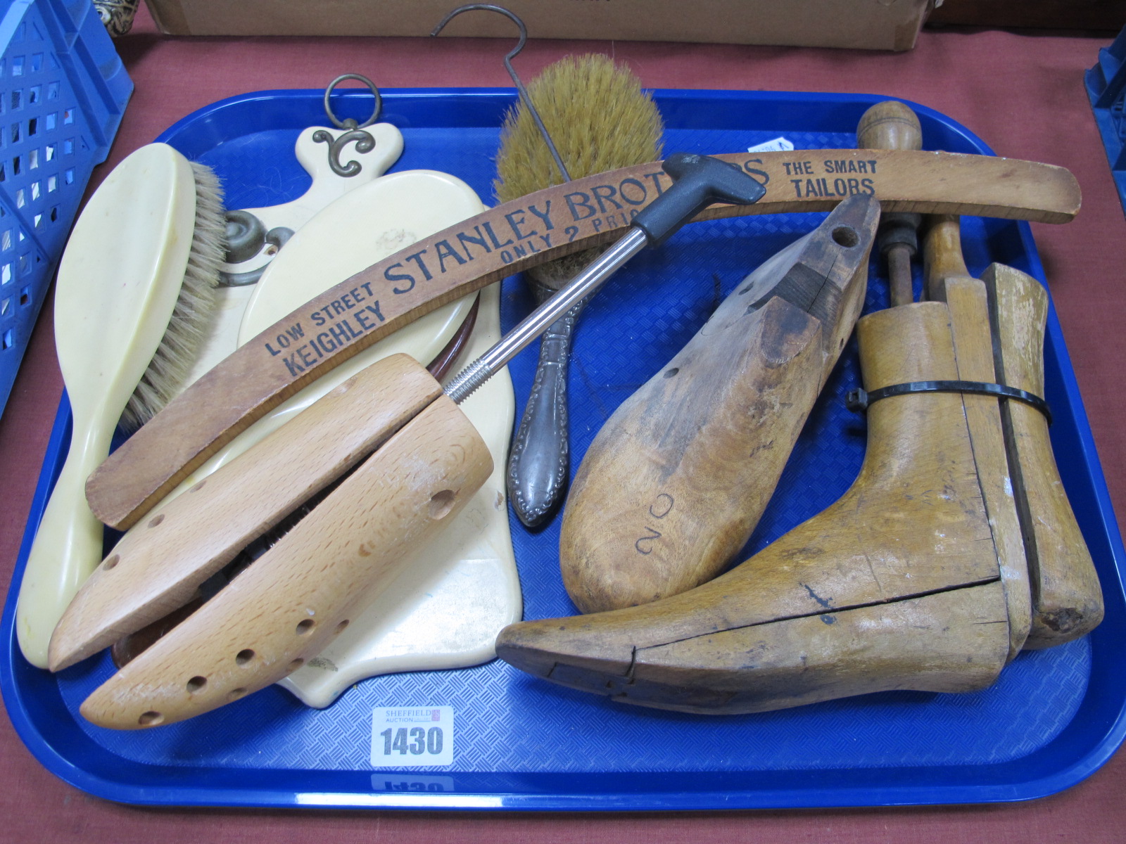 A Silver Backed Hair Brush, ivorine example shoe trees, etc:- One Tray.