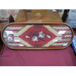 A XIX Century Beadwork Panel as a Teapot Tray, in oval mahogany frame on bun feet and brass castors,