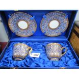 Pipatana Benjarong, pair of cups and saucers, hand painted, allover floral and gilt, in case.