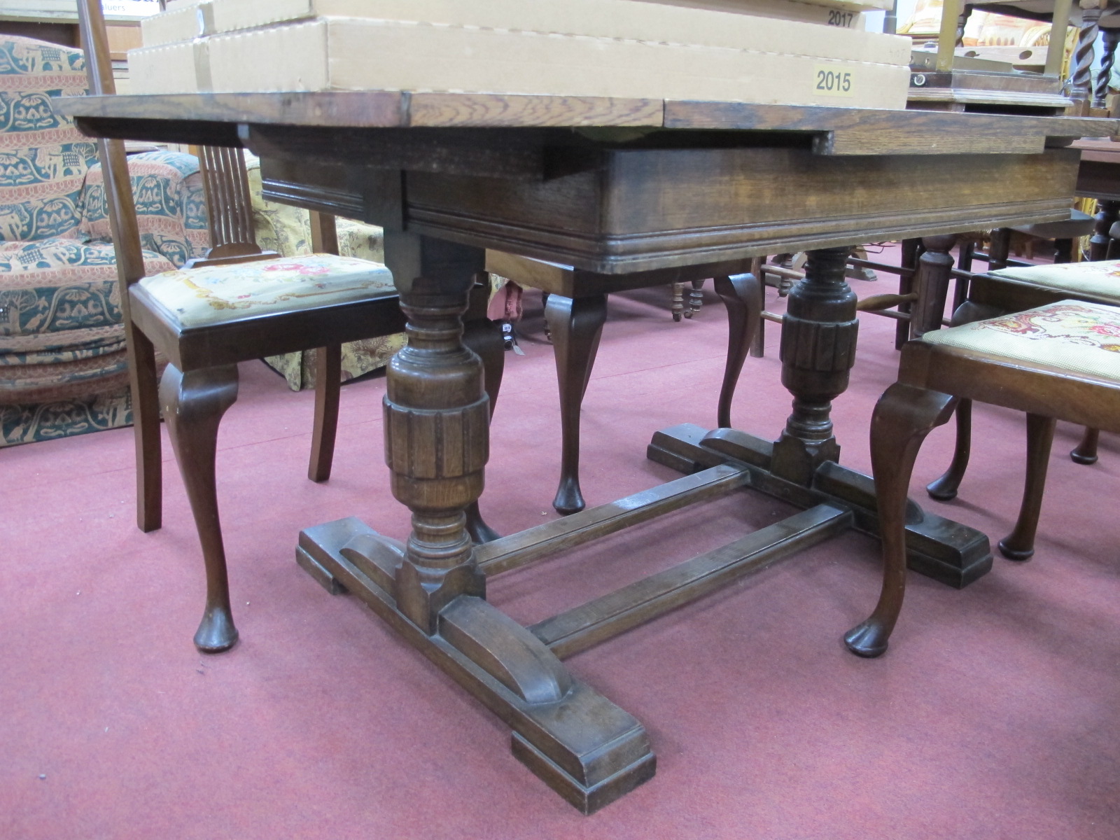 A XX Century Oak Draw Leaf Table, on cup cover supports.