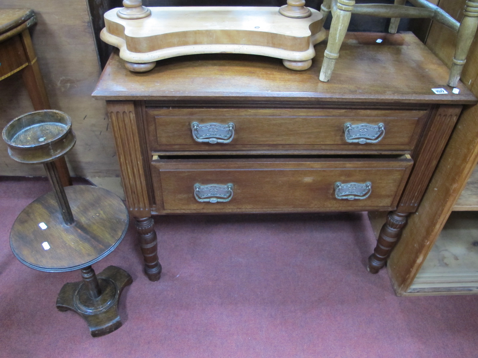 An Early XX Century Walnut Two Drawer Chest of Drawers, with reeded sides, turned supports, together