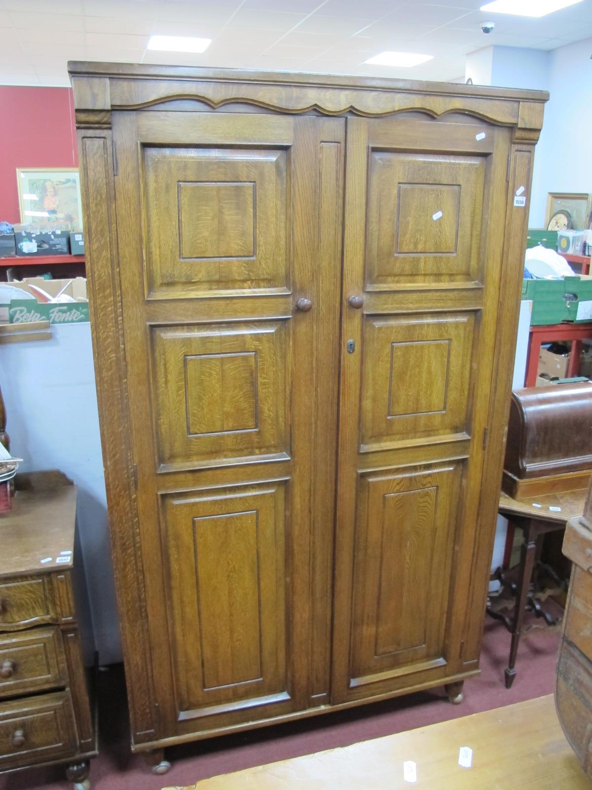 An XX Century Oak Wardrobe, with panelled doors, forefront on bun feet, 98cm.