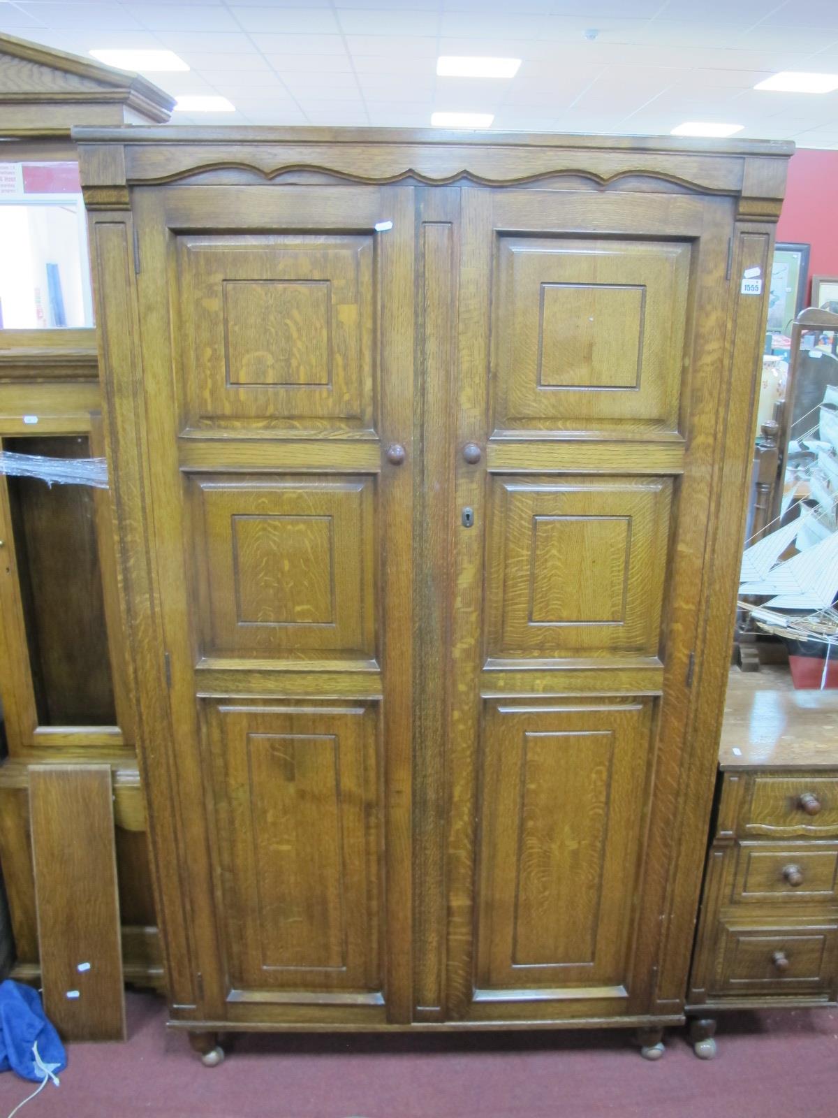 A XX Century Oak Wardrobe, with panelled doors, on bun forefront feet, 98cm wide.