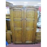 A XX Century Oak Wardrobe, with panelled doors, on bun forefront feet, 98cm wide.