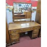 A XX Century Oak Dressing Table with central mirror, turned and block supports, central drawer,
