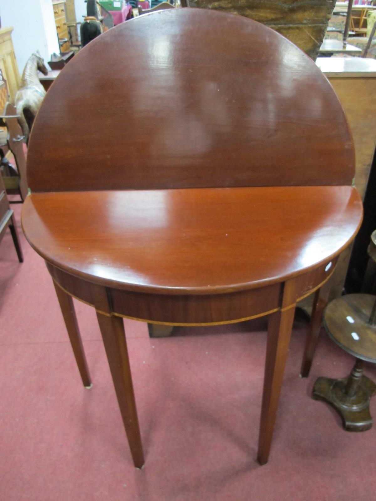 An Early Xx Century Mahogany Tea Table, with a fold over top on tapering legs.