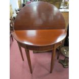 An Early Xx Century Mahogany Tea Table, with a fold over top on tapering legs.