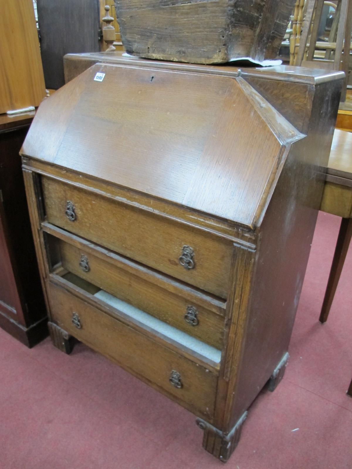 A XX Century Oak Bureau, with a fall front, fitted interiors, three long drawers, 76cm high.