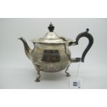 A Hallmarked Silver Tea Pot, CB, London 1902, of plain circular form with wavy rim, raised on