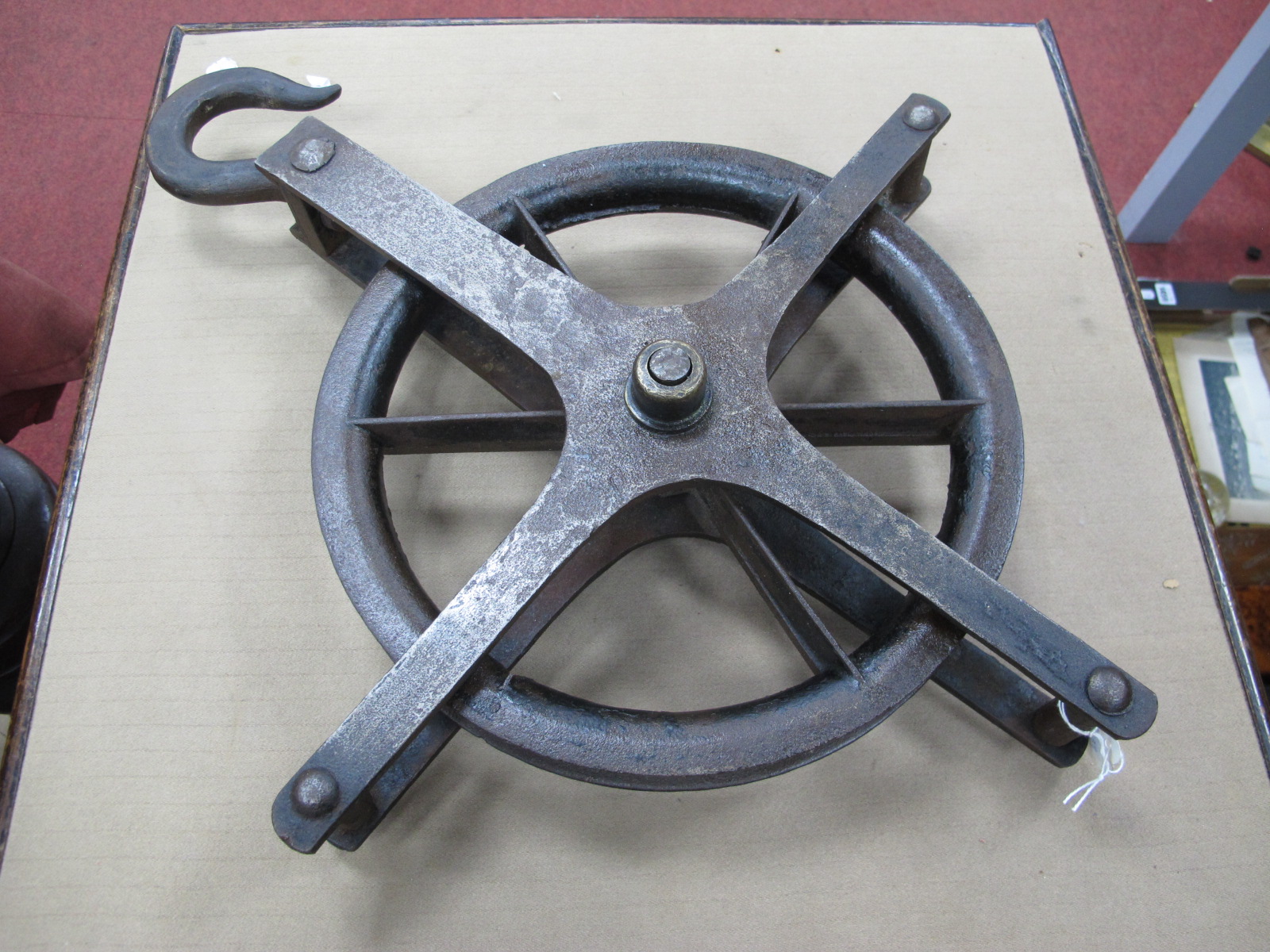 A Cast Iron Pulley Wheel, 29cm diameter, with hook to cruciform frame.