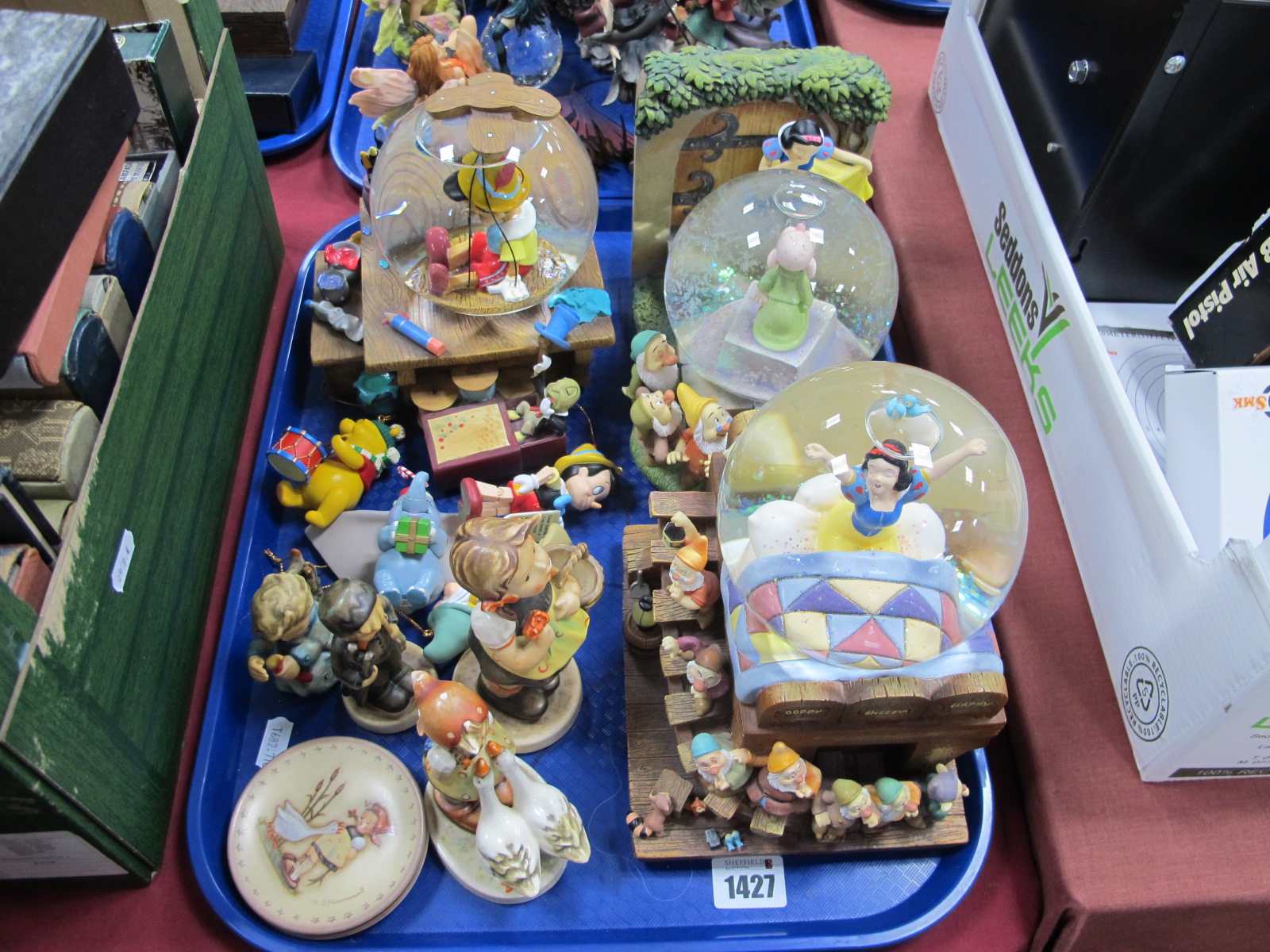 Two Snow White and One Pinocchio snow globes, having musical facility, four Hummel figures, etc:-