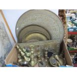 XIX Century Brass Candlesticks, Persian style brass plates, brass table top, bells:- One Box.