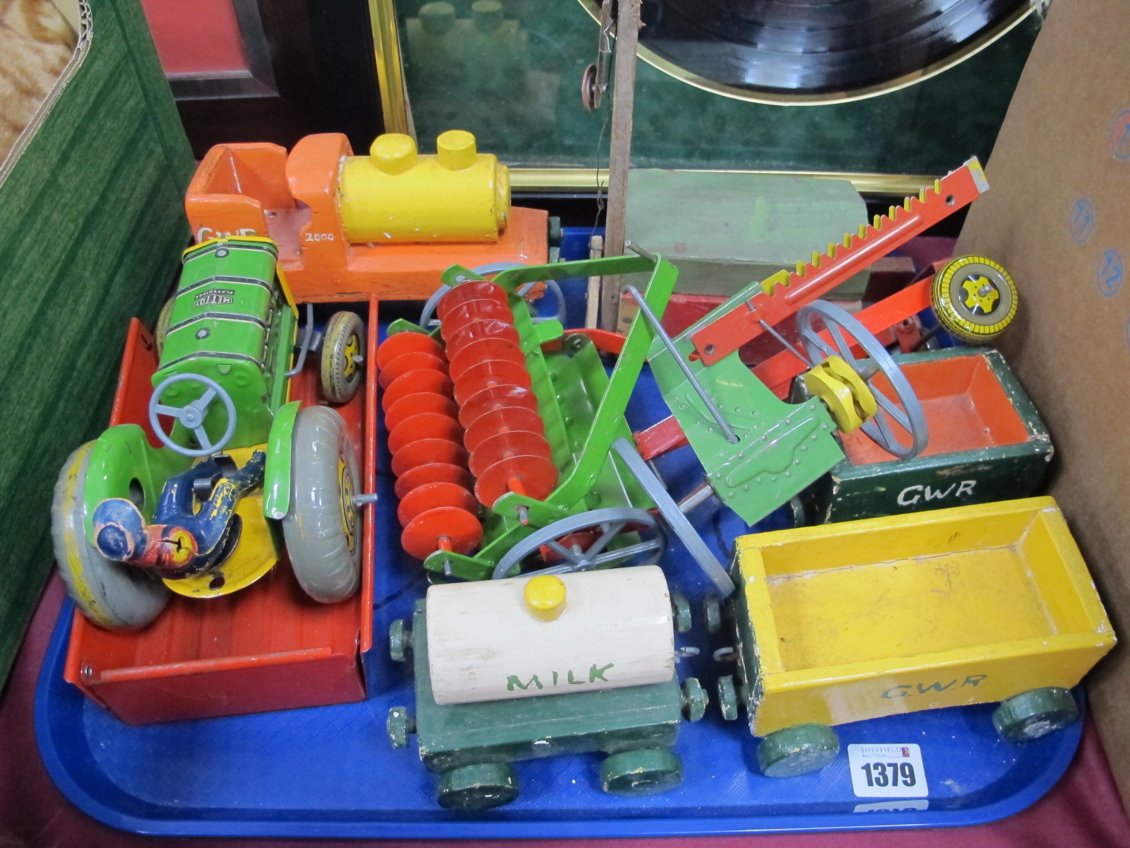 A Mid XX Century Tinplate Mettoy Tractor and Implement Set, plus driver; together with a handmade