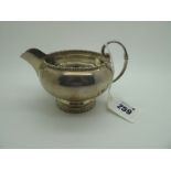 A Hallmarked Silver Jug, Walker & Hall, Sheffield 1932, of plain circular form with scroll handle,