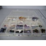 A Collection of Assorted Rocks / Crystals / Minerals, contained in a sectioned lidded box.