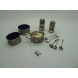 A Hallmarked Silver Five Piece Cruet Set, each of geometric pierced design with blue glass liners (