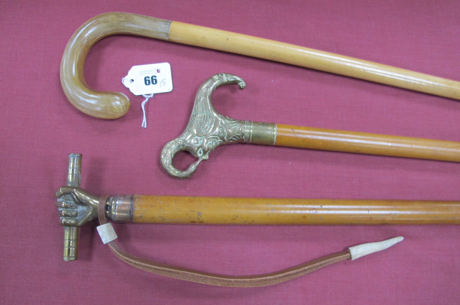 A Malaca Stick, with brass fist handle holding a baton, wrist hoop, copper ferrule, very long