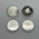 Four Silver Canadian Dollars, 1973, 1976, 1977 and 2001, all encapsulated.