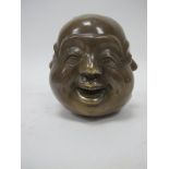 Oriental Brass Four Face Paperweight, with differing expressions to each side, 10.5cm high.