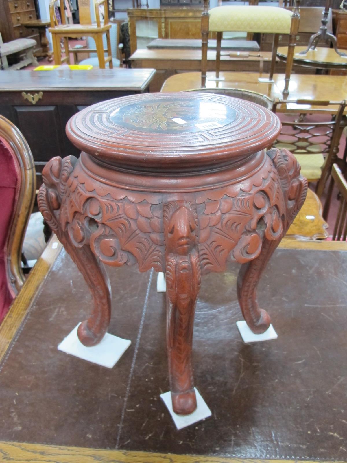 An Early XX Century Chinese Red Lacquer Stand, the circular top decorated with a phoenix within a