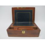 A Late XIX Century Mahogany Writing Slope, with brass cartouche to the lid, the interior with dark