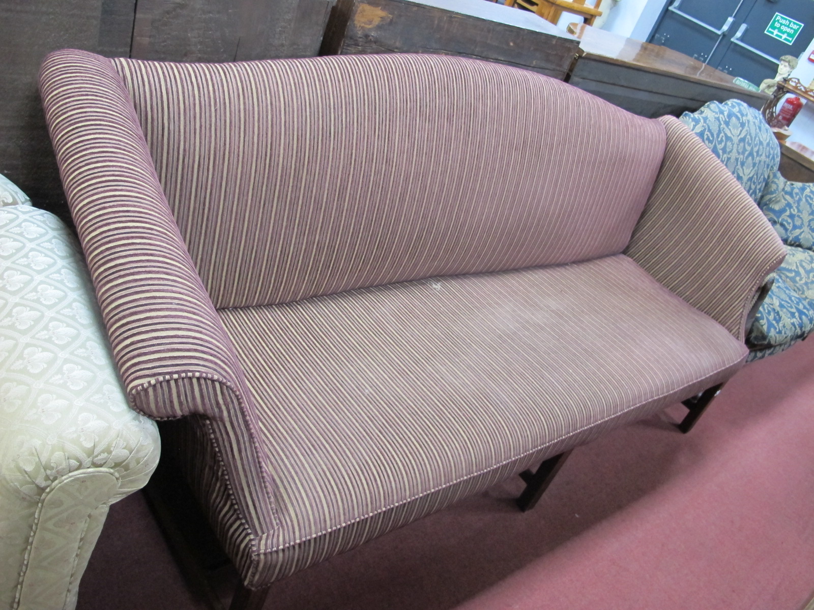 An XVIII Century Style Mahogany Settee, with upholstered back, seat and arms, on moulded legs united