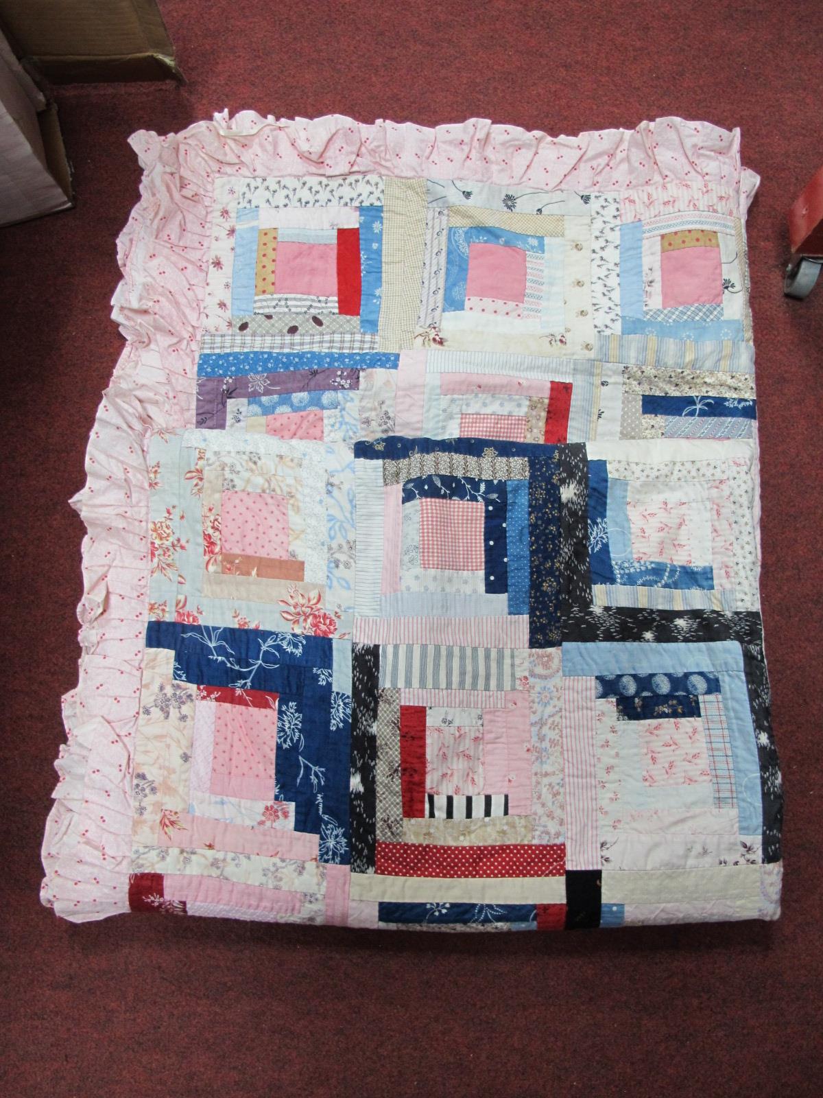 An Early/Mid XX Century Patchwork Quilt, worked in rectangles in the log cabin style, machine