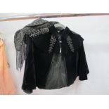 A Black Velvet Mourning Capelet, with jet type beaded collar; a black beaded and tassled mourning