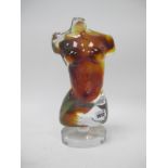 A Murano Glass Sculpture of a Female Torso, in clear and amber colours, raised on a pedestal oval