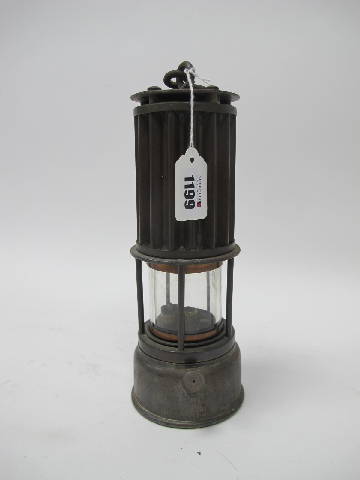 Miners Lamp, the Premier Lamp, Leeds, with corrugated upper body, 26cm high with handle down.