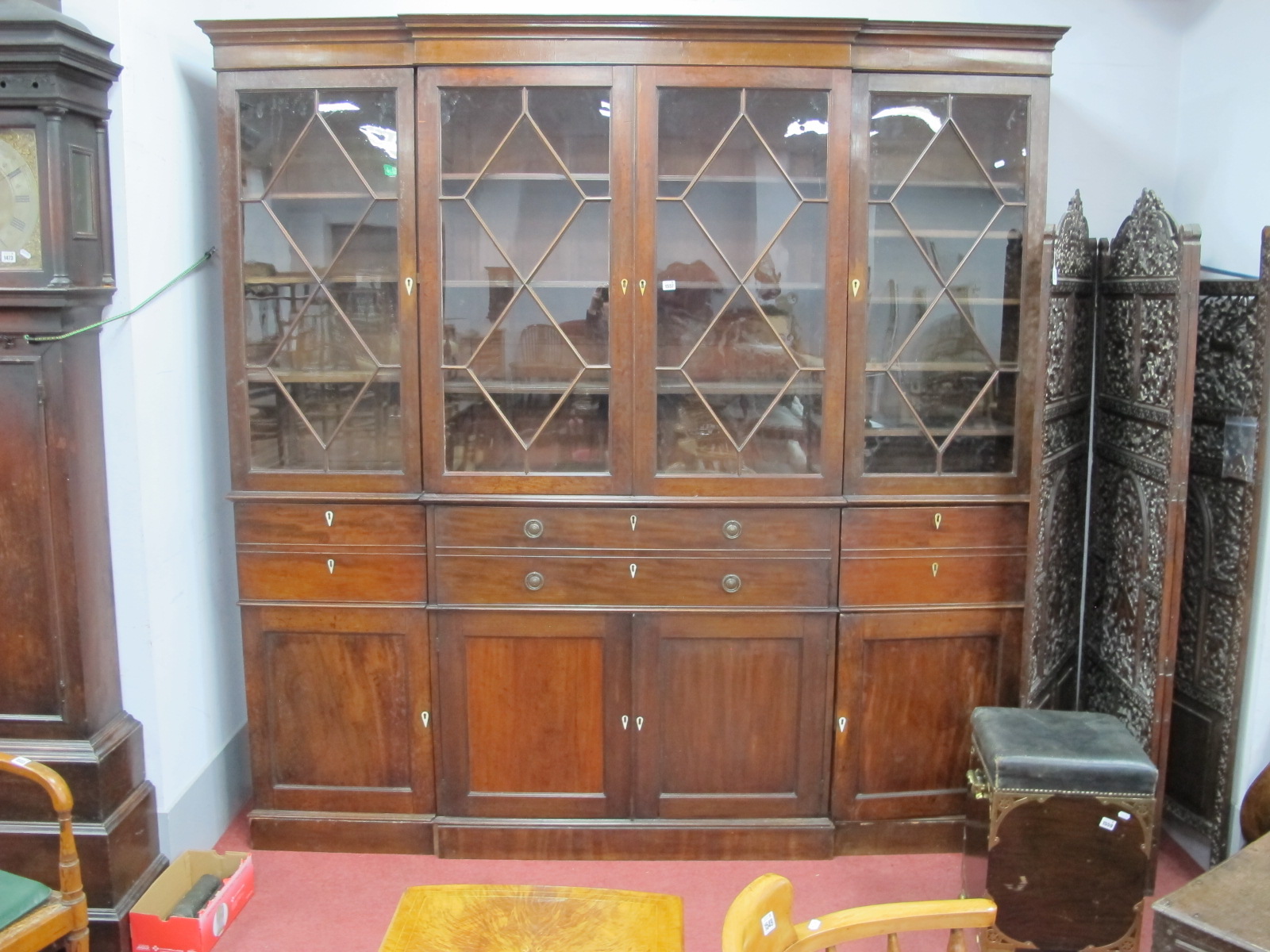 An Early XIX Century Mahogany Secretaire Breakfront Bookcase, with stepped cornice, glazed