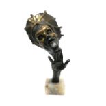 A Mid XX Century Bust, with raised hand, wearing a mask and head piece, the marble rectangular
