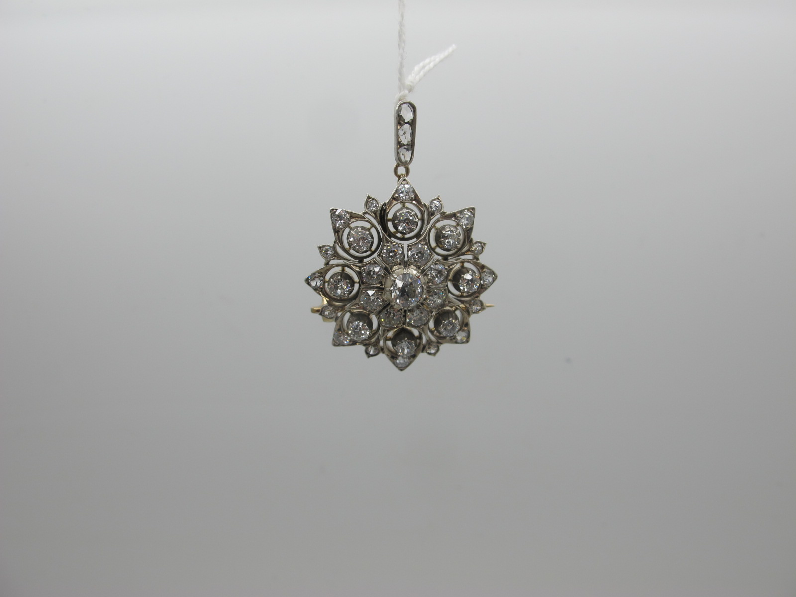 A Highly Attractive Victorian Diamond Set Pendant / Brooch, of cluster design with pierced detail,