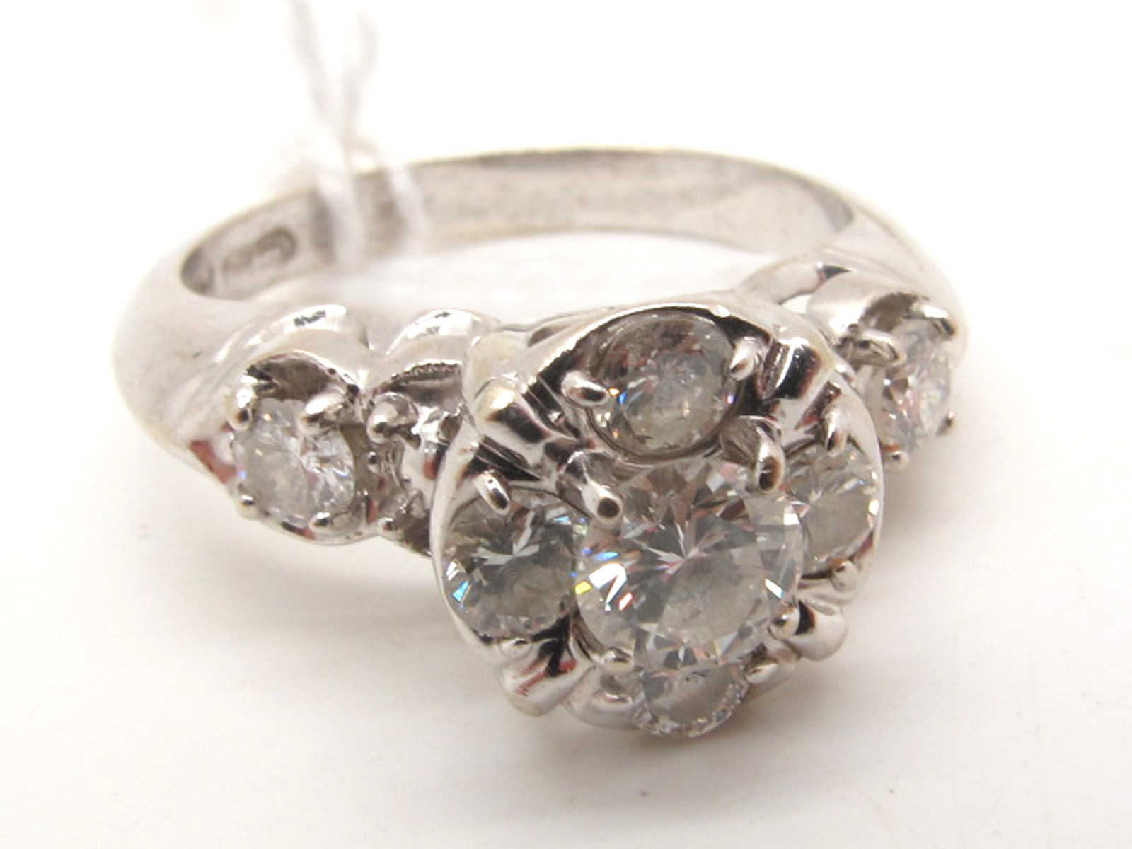 A Modern Diamond Cluster Ring, claw set with brilliant cut stones, high between brilliant cut