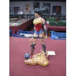 A DC Comics Wonder Woman Collectable Model Figure, presented on a WW gold and maroon coloured