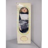 Genuine Porcelain Doll, approximately 68cm high, box in poor condition.