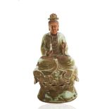 A CHINESE EARTHENWARE GUANYIN SEATED BODHISATTVA FIGURE