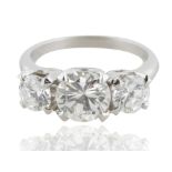 A 2.8 CT TRIPLE BRILLIANT ROUND-CUT DIAMOND RING SET IN PLATINUM