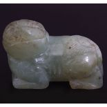 TWO EARLY CHINESE CELADON JADE RECUMBENT FOO DOGS