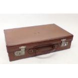 An early 20th century leather suitcase with key