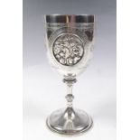 A Victorian silver goblet with engraved star decoration and oval cartouche embossed dogs, London