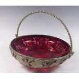 A cranberry glass bowl in gilt metal vine cast stand