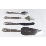 A silver handled cake slice, preserve spoon, cake fork and butter knife