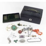 A collection of vintage costume jewellery in a leather box to include brooches, earrings etc